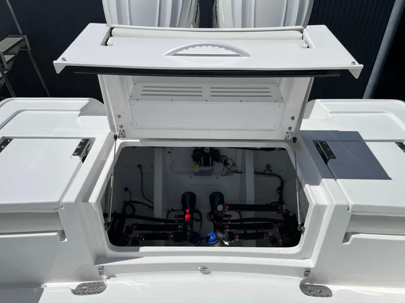 Slide: The Image of 2025 Tidewater 3100 Carolina Bay boat storage compartment with open hatch. - 8