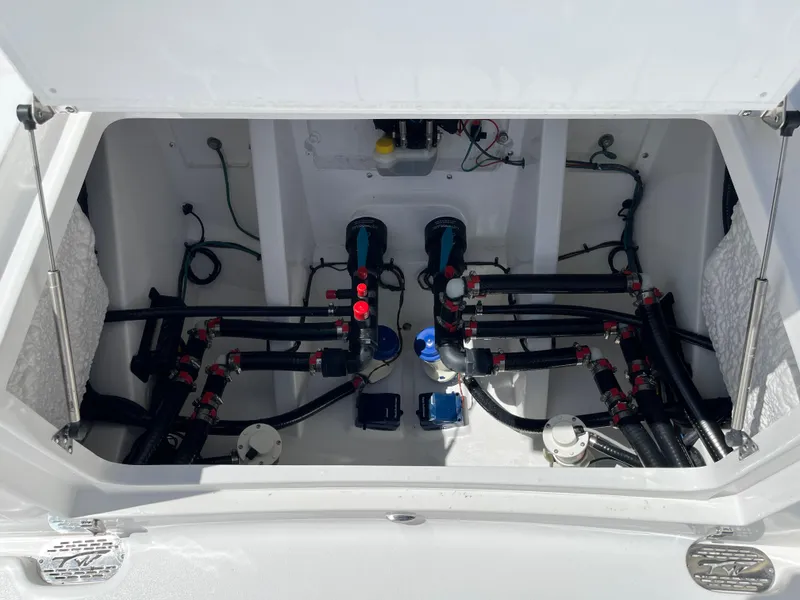 Slide: The Image of Tidewater 3100 Carolina Bay 2025 boat engine compartment with advanced wiring and plumbing. - 9