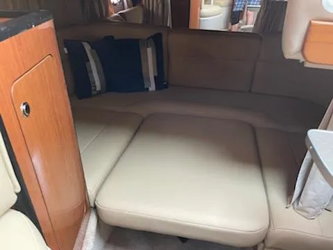 Slide: The Image of Interior of 2000 Chaparral 300 Signature boat with beige seating and cushions. - 10