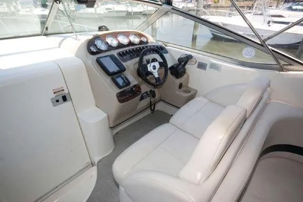 Slide: The Image of Interior of 2000 Chaparral 300 Signature boat with steering wheel and dashboard controls. - 6