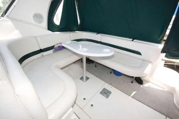 Slide: The Image of Interior of 2000 Chaparral 300 Signature boat with white seating and table. - 8