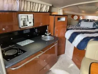 Slide: The Image of Interior of 2000 Chaparral 300 Signature boat with kitchen and cozy sleeping area. - 9