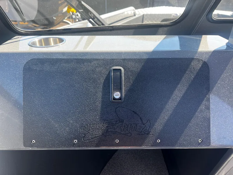 Slide: The Image of 2024 Fish Rite 200 Sportsman boat dashboard with storage compartment and cup holder. - 14