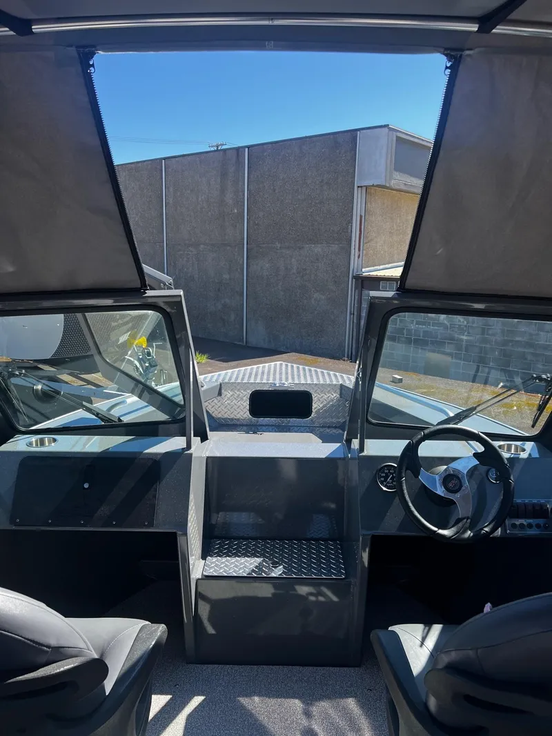 Slide: The Image of Interior view of 2024 Fish Rite 200 Sportsman boat with steering wheel and seating. - 17