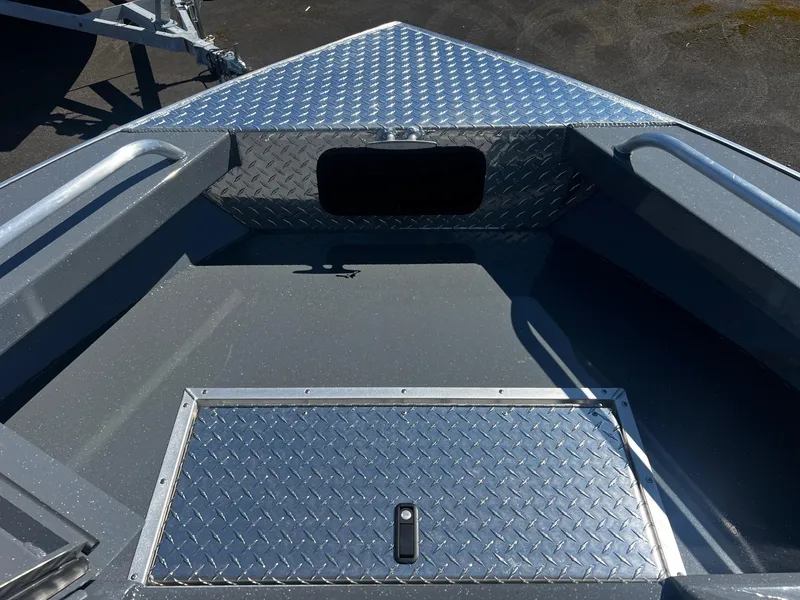 Slide: The Image of 2024 Fish Rite 200 Sportsman boat bow with storage compartment and diamond plate flooring. - 18