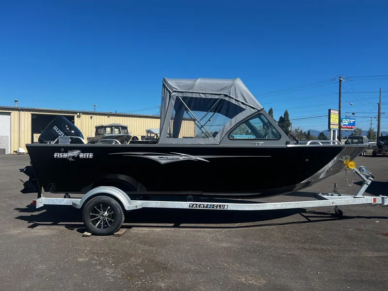 Slide: The Image of 2024 Fish Rite 200 Sportsman boat on trailer, black exterior, parked outdoors. - 3
