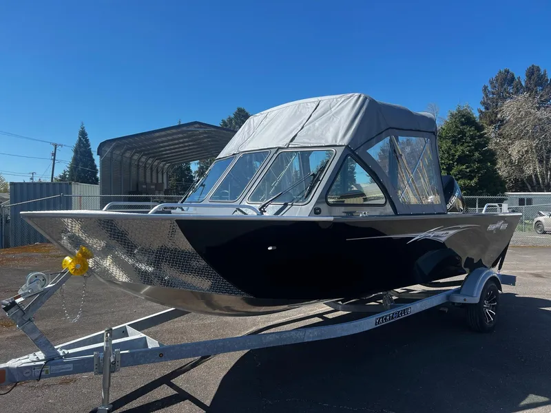 Slide: The Image of 2024 Fish Rite 200 Sportsman boat on trailer, black exterior, parked outdoors. - 7