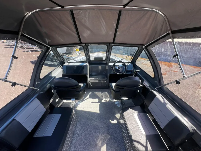 Slide: The Image of Interior of 2024 Fish Rite 200 Sportsman boat with seating and steering console. - 8