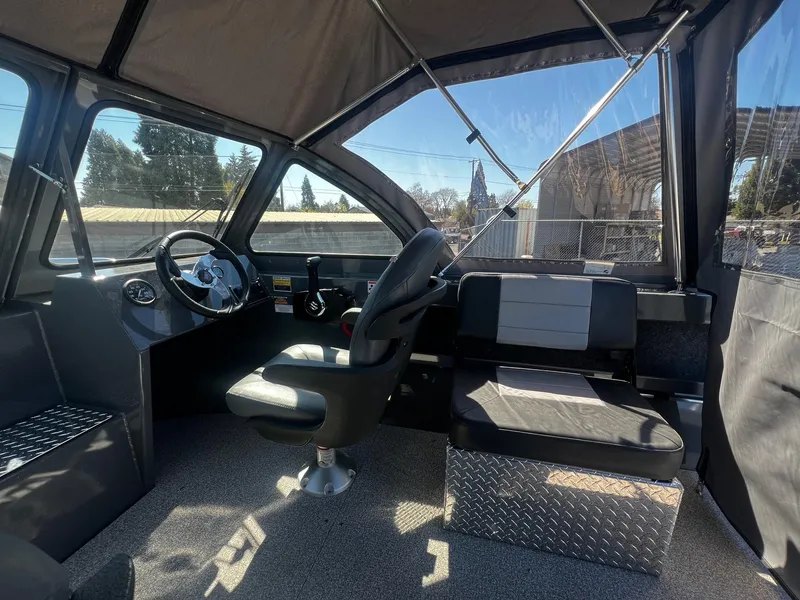 Slide: The Image of Interior of 2024 Fish Rite 200 Sportsman boat with steering wheel and seating. - 9