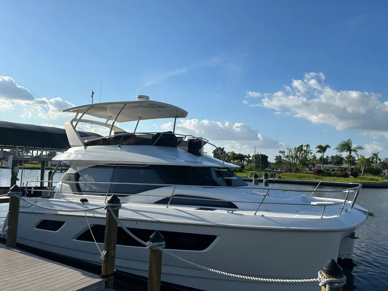 Slide: The Image of 2020 Aquila 44 Yacht docked under a clear blue sky. - 23