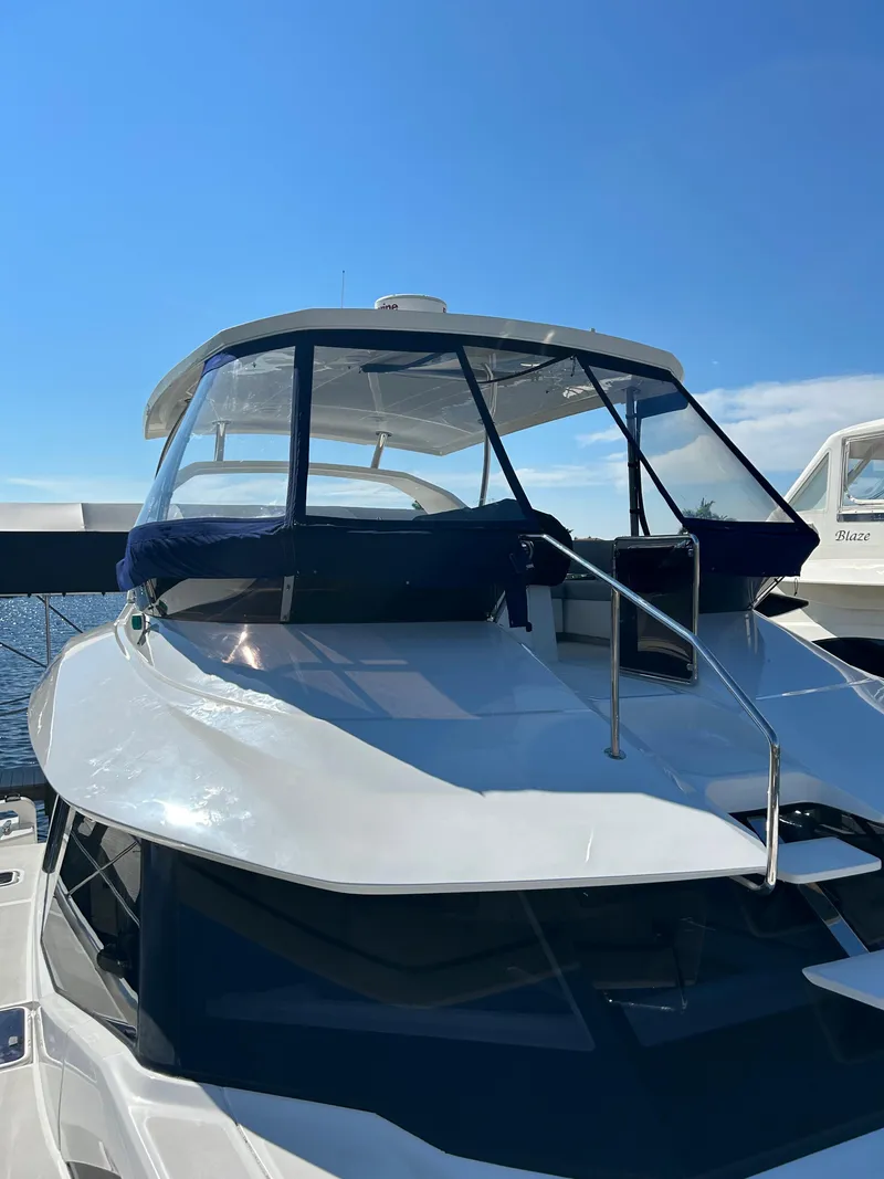 Slide: The Image of 2020 Aquila 44 Yacht with sleek design under clear blue sky. - 25