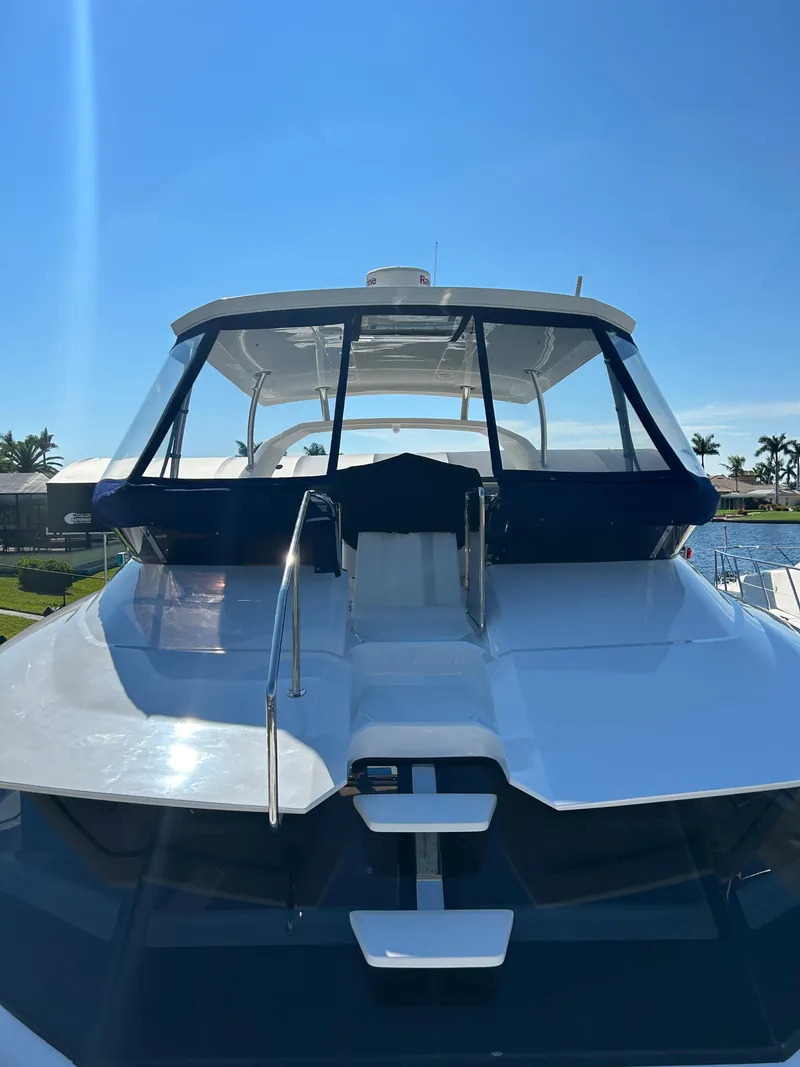 Slide: The Image of Aquila 44 Yacht 2020, sleek design, docked under clear blue sky. - 26