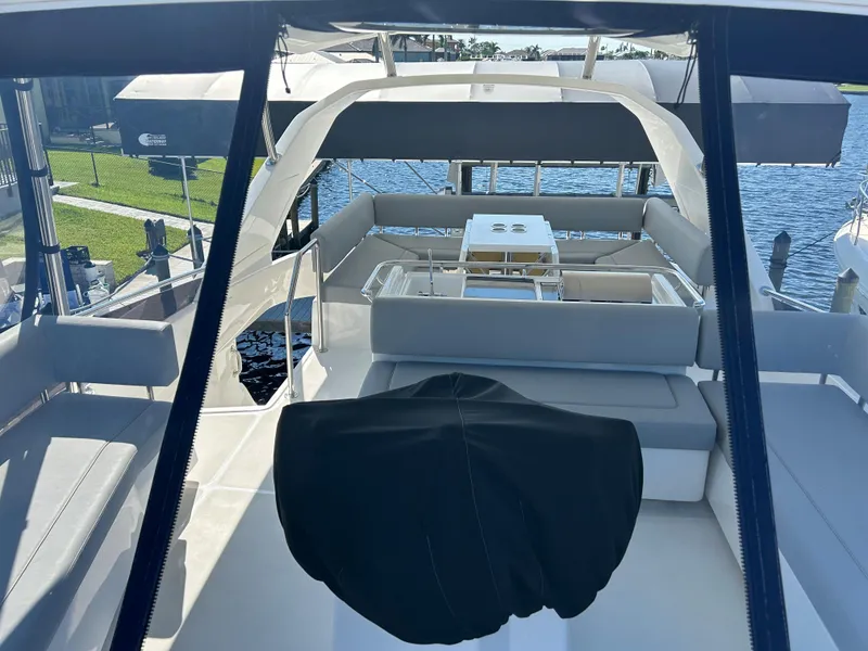 Slide: The Image of 2020 Aquila 44 Yacht interior with seating and table, overlooking water. - 29