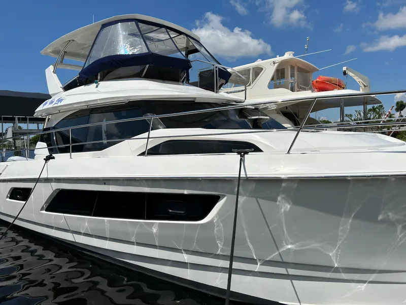 Slide: The Image of 2020 Aquila 44 Yacht docked under a clear blue sky. - 3