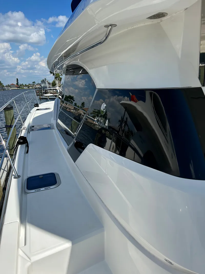 Slide: The Image of 2020 Aquila 44 Yacht side view with sleek design and reflective windows. - 40
