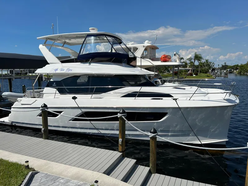 Slide: The Image of Aquila 44 Yacht 2020 docked at marina under clear blue sky. - 43