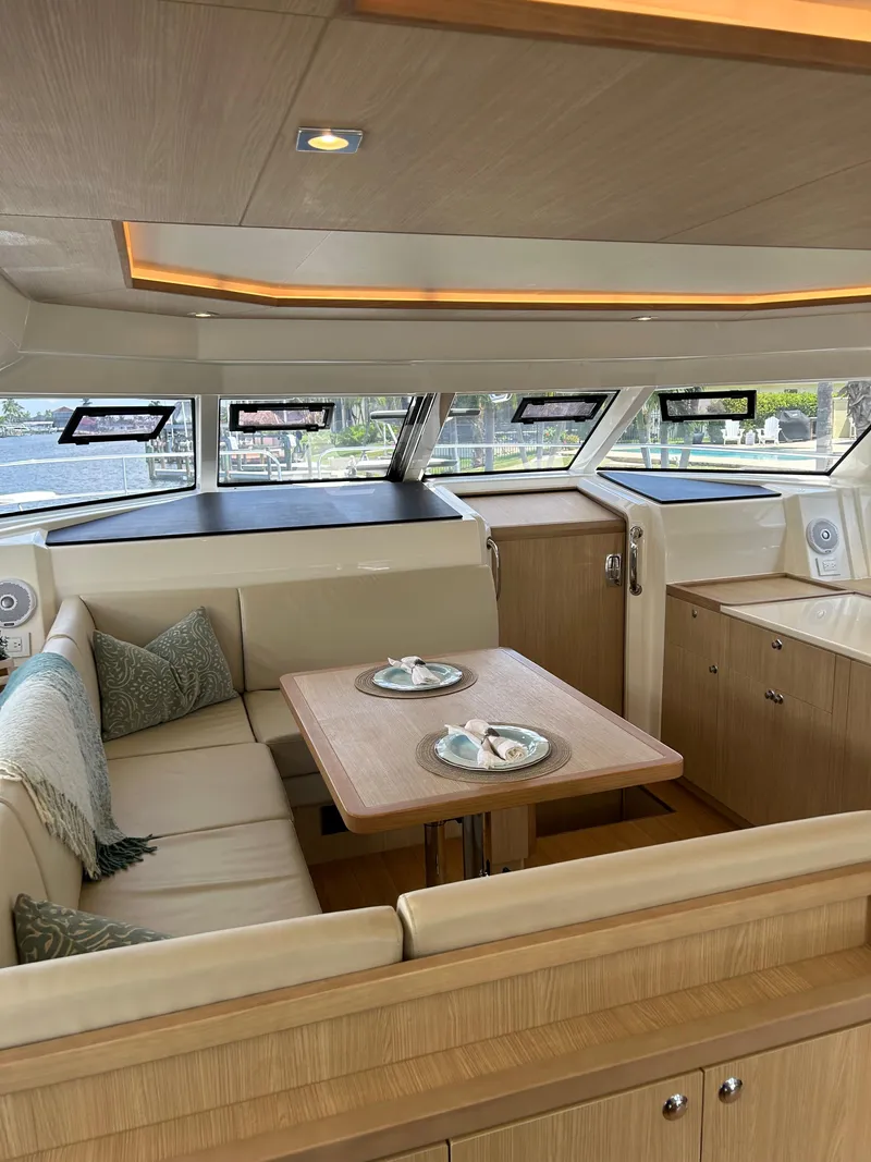 Slide: The Image of Interior of 2020 Aquila 44 Yacht with elegant dining area and panoramic windows. - 46
