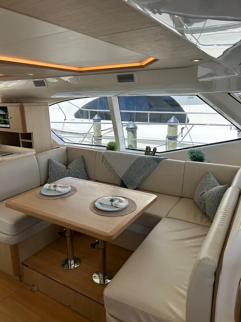 Slide: The Image of Luxurious interior of 2020 Aquila 44 Yacht with elegant dining area and panoramic windows. - 47