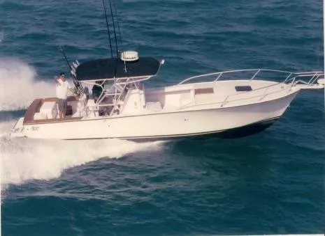 The Image of 2000 Stuart Angler 32 Center Console/Cutty boat cruising on open water. - 0