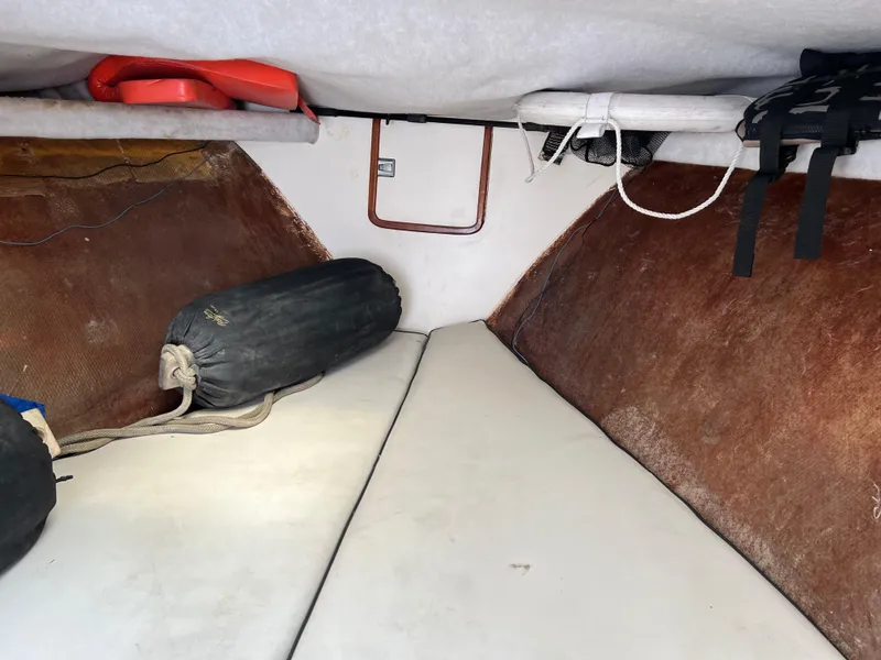 Slide: The Image of Interior of 2000 Stuart Angler 32 Center Console/Cutty boat with cushions and storage. - 17