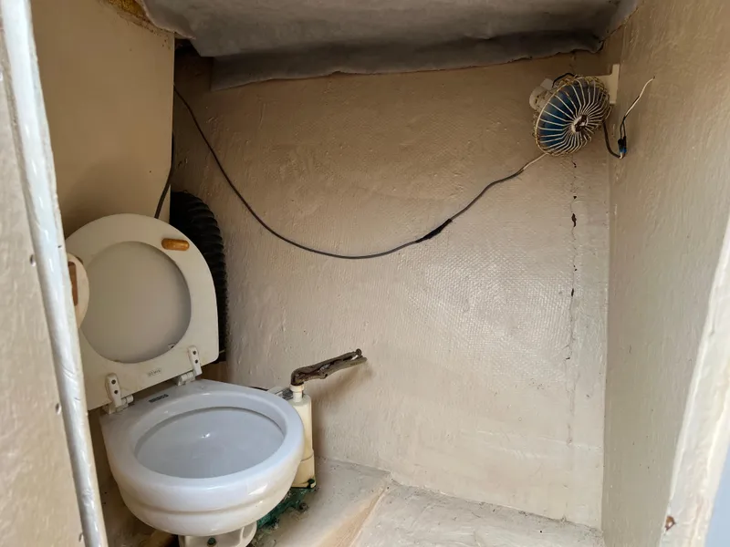 Slide: The Image of Boat bathroom with toilet and fan, Stuart Angler 32 Center Console/Cutty, 2000 model. - 21