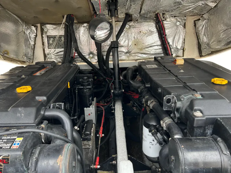 Slide: The Image of Engine compartment of a 2000 Stuart Angler 32 Center Console/Cutty boat, showing detailed machinery. - 26