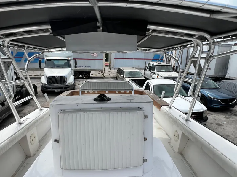Slide: The Image of 2000 Stuart Angler 32 Center Console boat in a parking lot with trucks and cars. - 36