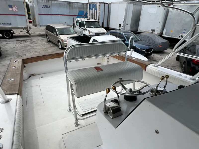 Slide: The Image of 2000 Stuart Angler 32 Center Console boat interior with steering wheel and seating. - 40