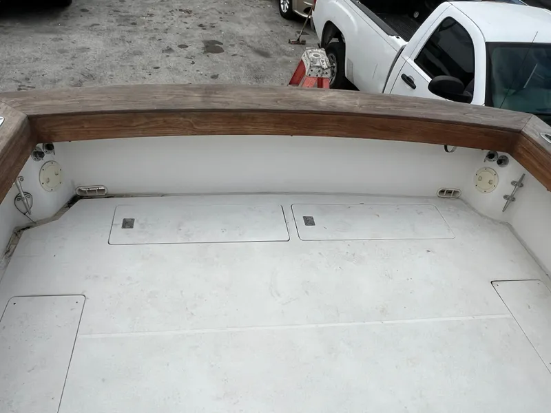 Slide: The Image of 2000 Stuart Angler 32 Center Console boat deck with wooden railings and storage compartments. - 42