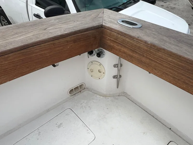 Slide: The Image of 2000 Stuart Angler 32 Center Console/Cutty boat deck with wooden railing and cleat. - 43
