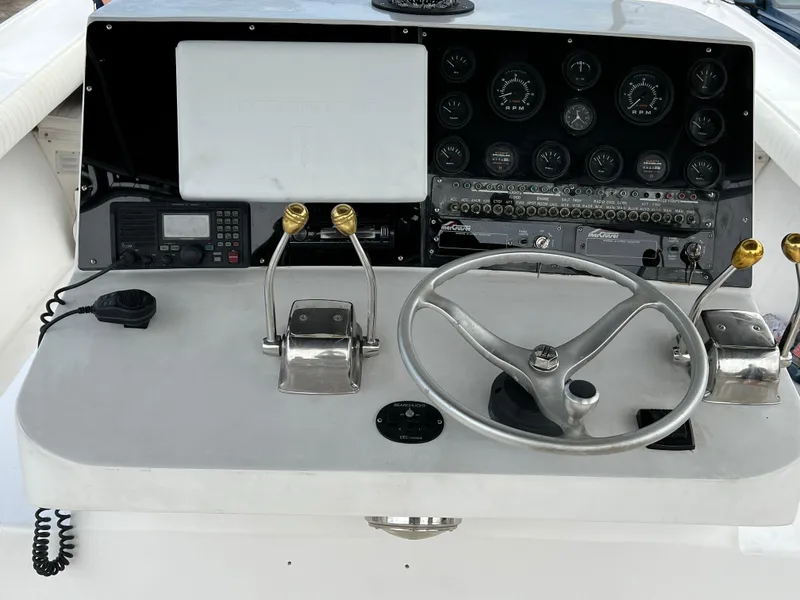 Slide: The Image of Control panel of a 2000 Stuart Angler 32 Center Console/Cutty boat with steering wheel and gauges. - 45