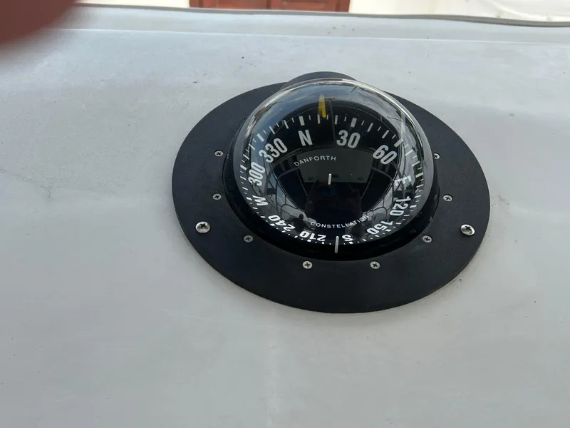 Slide: The Image of Compass on 2000 Stuart Angler 32 Center Console/Cutty boat dashboard. - 48