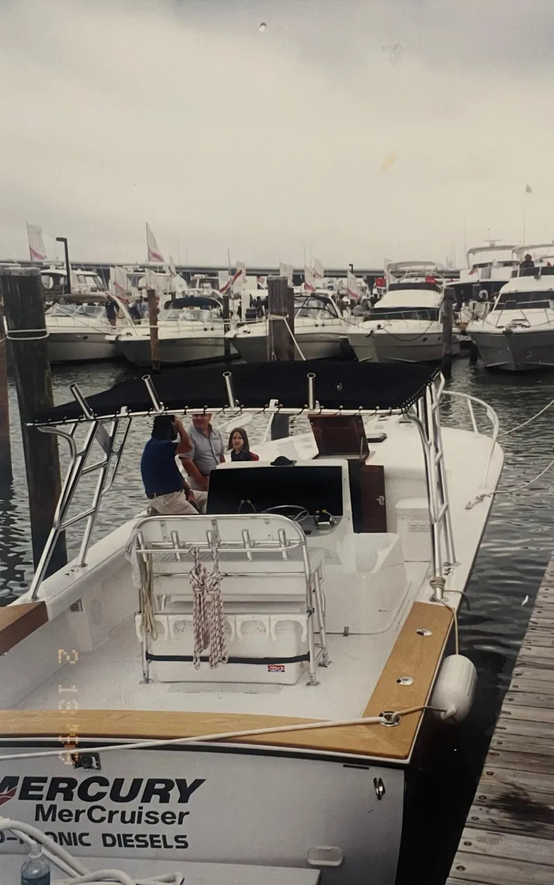 Slide: The Image of 2000 Stuart Angler 32 Center Console boat docked at marina with people onboard. - 6