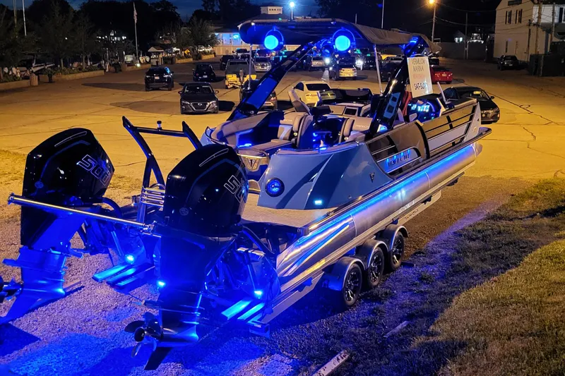 The Image of 2025 Trifecta 25 Sport RF9 DC 3.0+ boat with blue LED lights at night. - 0
