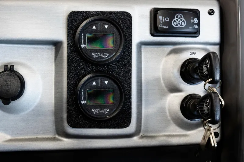 Slide: The Image of Control panel of 2025 Trifecta 25 Sport RF9 DC 3.0+ with gauges and ignition keys. - 19