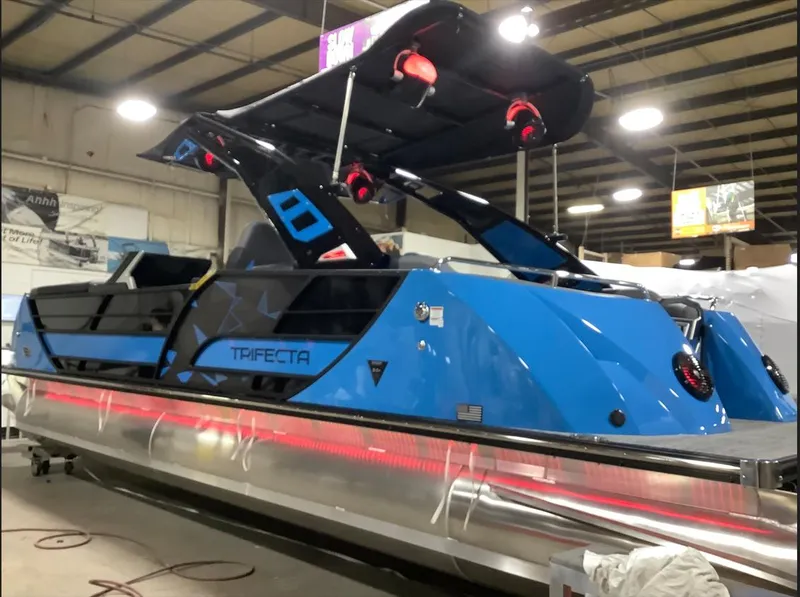 Slide: The Image of 2025 Trifecta 25 Sport RF9 DC 3.0+ pontoon boat in a showroom. - 2