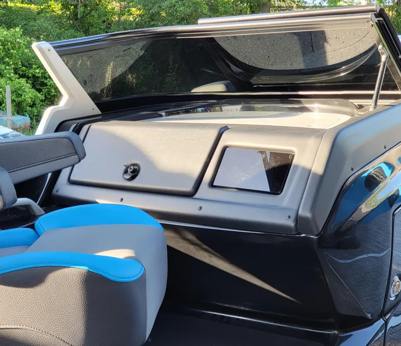 Slide: The Image of Interior dashboard of 2025 Trifecta 25 Sport RF9 DC 3.0+ boat with blue-accented seat. - 9