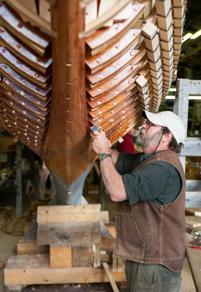Slide: The Image of Craftsman working on the hull of a 1931 Sparkman & Stephens 36 Sloop. - 11