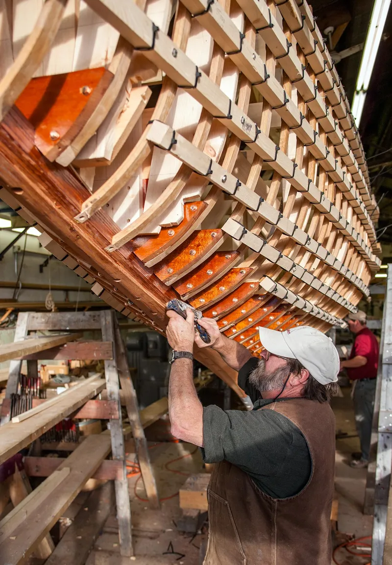 Slide: The Image of Craftsman working on the hull of a 1931 Sparkman & Stephens 36 Sloop. - 14