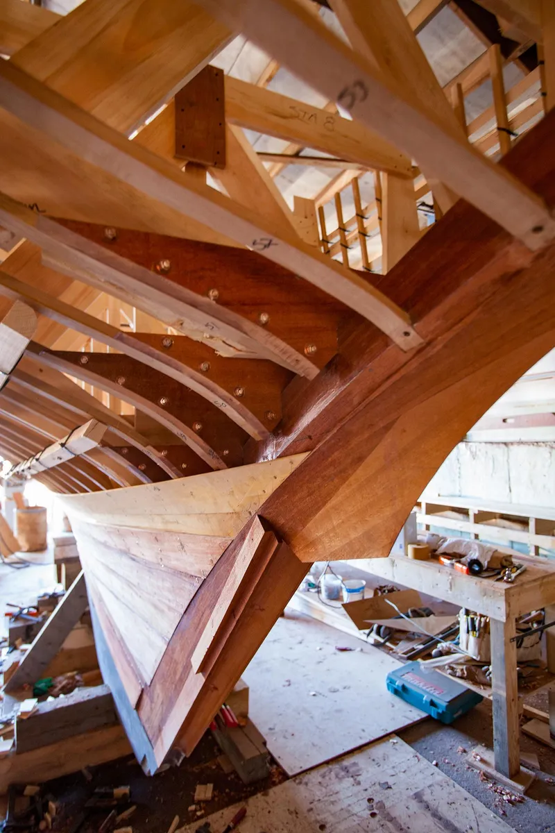 Slide: The Image of Wooden hull construction of a 1931 Sparkman & Stephens 36 Sloop in a workshop. - 23