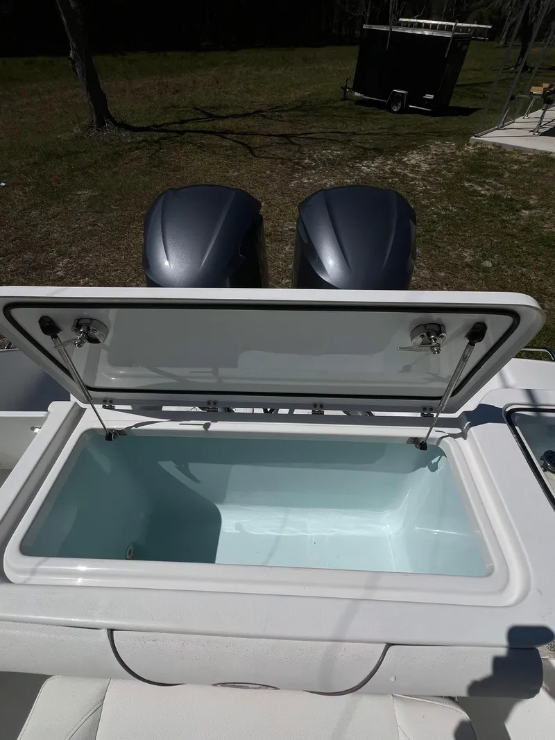 Slide: The Image of Open storage compartment on a 2018 Sea Hunt Gamefish 30 boat with dual engines. - 11