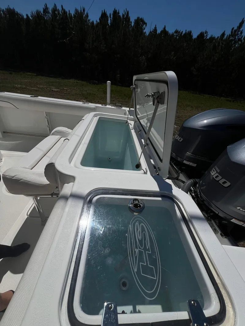 Slide: The Image of 2018 Sea Hunt Gamefish 30 boat with open storage compartment and dual engines. - 12