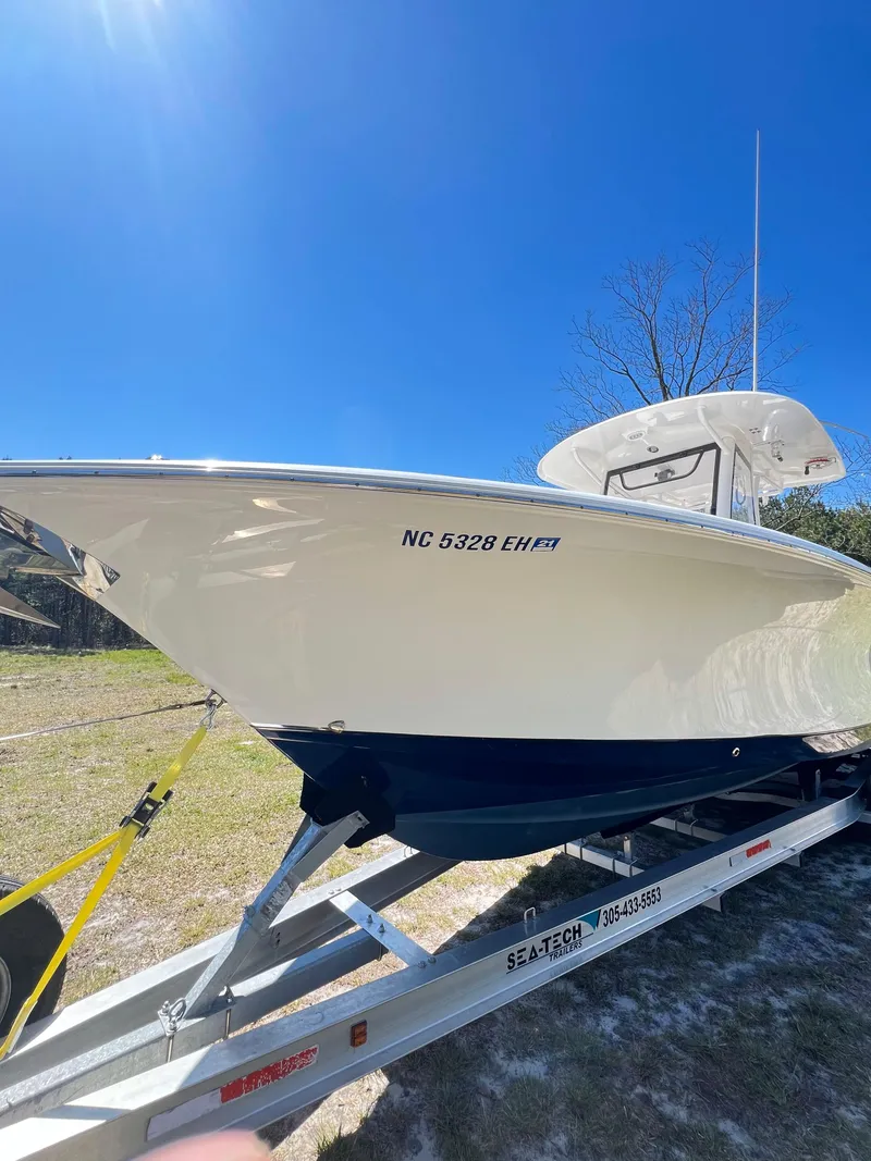 Slide: The Image of 2018 Sea Hunt Gamefish 30 boat on trailer under clear blue sky. - 17