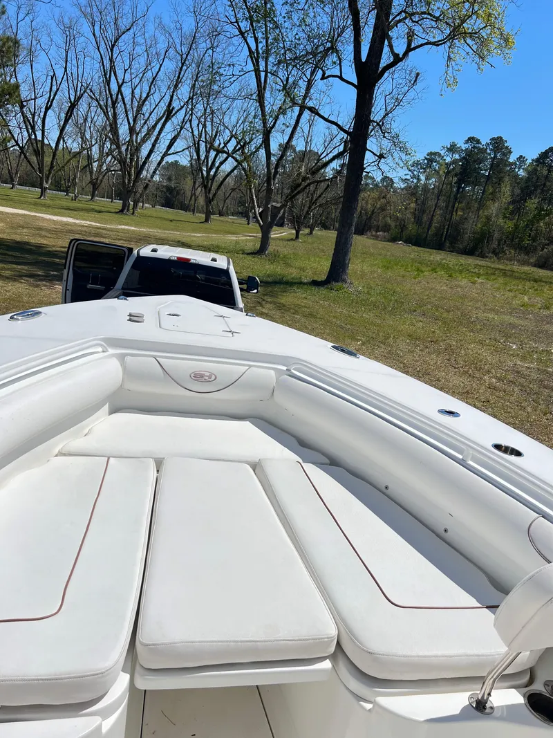 Slide: The Image of 2018 Sea Hunt Gamefish 30 boat on trailer in grassy area with trees. - 21