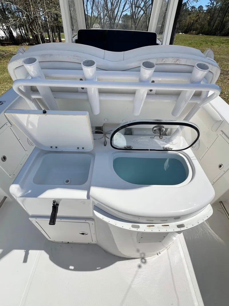 Slide: The Image of 2018 Sea Hunt Gamefish 30 boat interior with sink and storage compartments. - 3