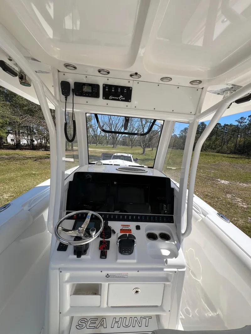 Slide: The Image of 2018 Sea Hunt Gamefish 30 boat cockpit with steering wheel and control panel. - 4