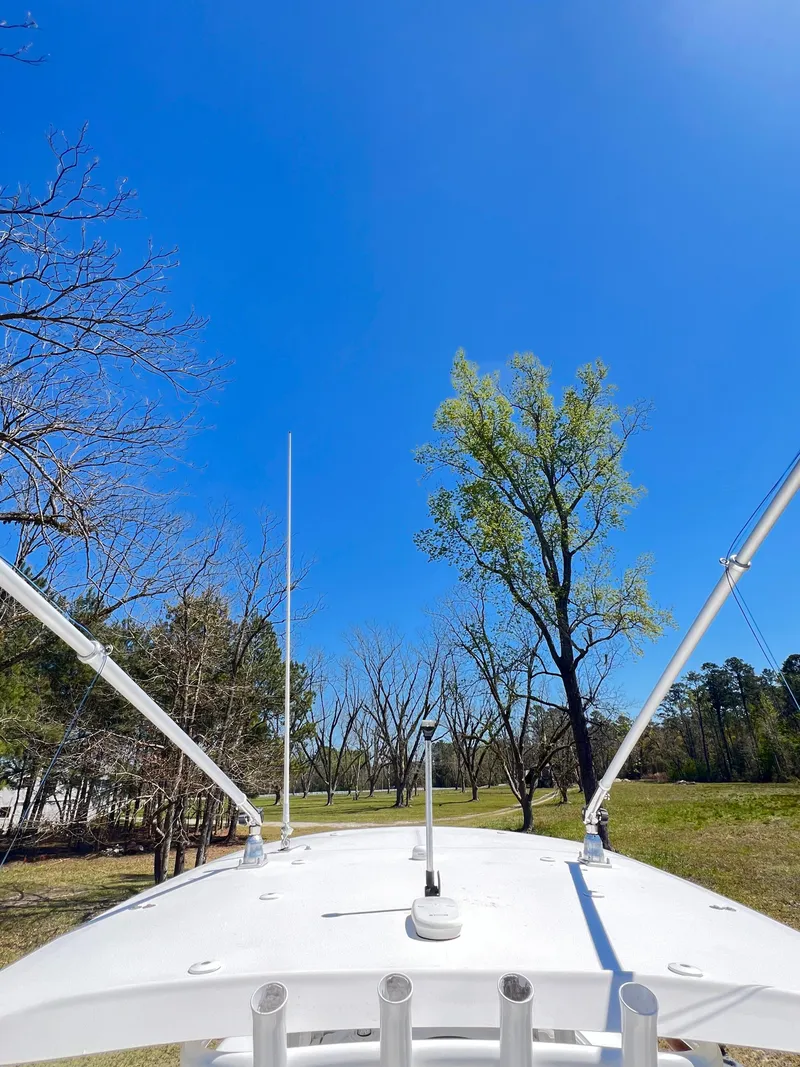 Slide: The Image of 2018 Sea Hunt Gamefish 30 boat against clear blue sky and trees. - 7