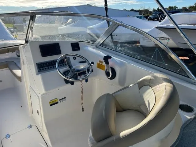 Slide: The Image of 2020 Key West 239 DFS boat cockpit with steering wheel and control panel. - 15