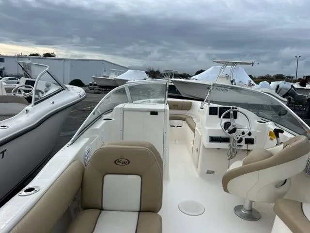 Slide: The Image of 2020 Key West 239 DFS boat interior with beige seating and steering console. - 18