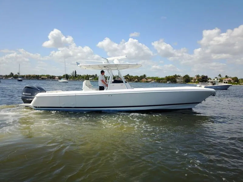 Slide: The Image of 2013 Intrepid 327 Center Console boat cruising on a sunny day. - 4